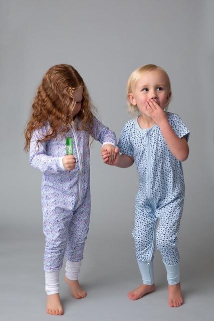 Two children wearing Little Zips onesies